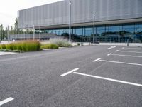 a view of a parking lot from the street in front of the building where they are sitting