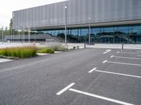 a view of a parking lot from the street in front of the building where they are sitting