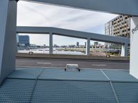 a skateboard is parked on the platform of an overpassing area near other buildings