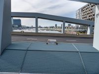 a skateboard is parked on the platform of an overpassing area near other buildings