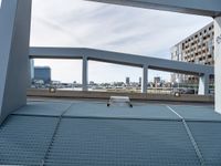 a skateboard is parked on the platform of an overpassing area near other buildings