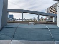 a skateboard is parked on the platform of an overpassing area near other buildings