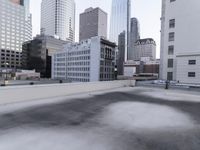 a view of a city on the roof of a building with snow on the ground
