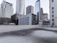 a view of a city on the roof of a building with snow on the ground