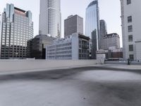 a view of a city on the roof of a building with snow on the ground