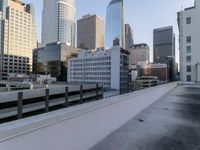 a view of a city on the roof of a building with snow on the ground