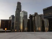 a view of a city with many tall buildings in the sunset hours and other buildings on either side