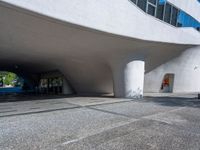 a white building that looks like it is sitting under the bridge in front of it