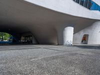 a white building that looks like it is sitting under the bridge in front of it