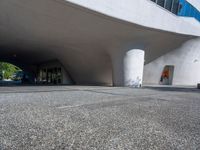 a white building that looks like it is sitting under the bridge in front of it