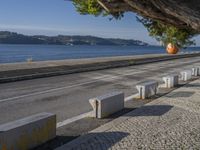 there are many grey concrete blocks next to the water of the ocean that are lined up along