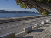 there are many grey concrete blocks next to the water of the ocean that are lined up along