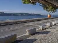 there are many grey concrete blocks next to the water of the ocean that are lined up along