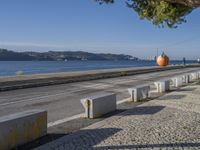 there are many grey concrete blocks next to the water of the ocean that are lined up along