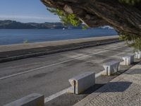 there are many grey concrete blocks next to the water of the ocean that are lined up along