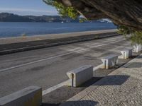 there are many grey concrete blocks next to the water of the ocean that are lined up along