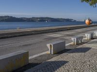 there are many grey concrete blocks next to the water of the ocean that are lined up along