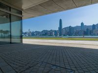 a view of the skyline from a walkway in front of buildings with a blue sky