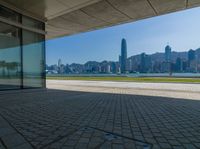 a view of the skyline from a walkway in front of buildings with a blue sky