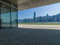 a view of the skyline from a walkway in front of buildings with a blue sky