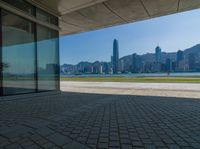 a view of the skyline from a walkway in front of buildings with a blue sky