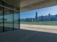 a view of the skyline from a walkway in front of buildings with a blue sky