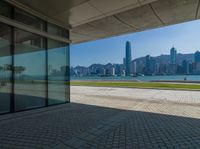 a view of the skyline from a walkway in front of buildings with a blue sky