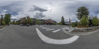 the view of the street from the front and center point of the view of a man crossing a road in the middle of town