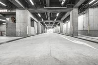 an empty parking garage has multiple spots for people to ride in the way through it