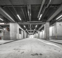 an empty parking garage has multiple spots for people to ride in the way through it