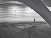 a black and white photo of an indoor swimming pool, and it has curved walls