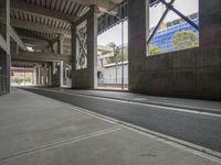 a street in an empty building that's partially painted gray with the top half up and bottom down