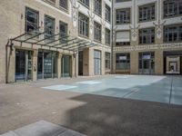 a large courtyard with some windows near an empty building is pictured on the opposite side