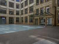 a large courtyard with some windows near an empty building is pictured on the opposite side