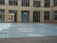 a large courtyard with some windows near an empty building is pictured on the opposite side