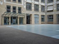 a large courtyard with some windows near an empty building is pictured on the opposite side