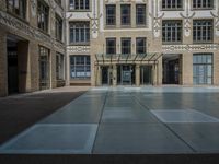 a large courtyard with some windows near an empty building is pictured on the opposite side