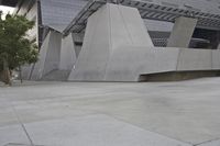 a skateboarder in mid air performing tricks on a skate park ramp in an outdoor area