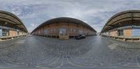 this fisheye view shows an exterior and car park with cobblestones in the foreground