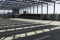 this is a picture of a covered area with concrete floors and a large roof and some windows