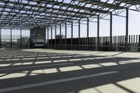 this is a picture of a covered area with concrete floors and a large roof and some windows