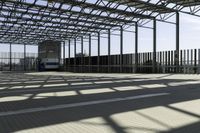 this is a picture of a covered area with concrete floors and a large roof and some windows