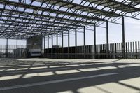 this is a picture of a covered area with concrete floors and a large roof and some windows