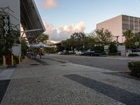 a crosswalk and walkway in an urban setting with the light in the sky shining behind it