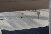 the corner of a street next to an overpass where a person is riding his bicycle