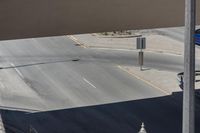 the corner of a street next to an overpass where a person is riding his bicycle