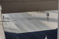 the corner of a street next to an overpass where a person is riding his bicycle