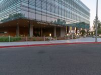 two grey blocks sitting next to a tall building on a sidewalk in front of grass