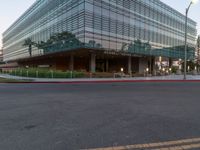 two grey blocks sitting next to a tall building on a sidewalk in front of grass