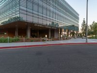 two grey blocks sitting next to a tall building on a sidewalk in front of grass